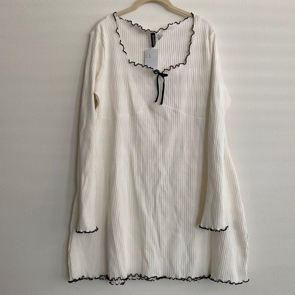 Cream dress with black trim and bow
